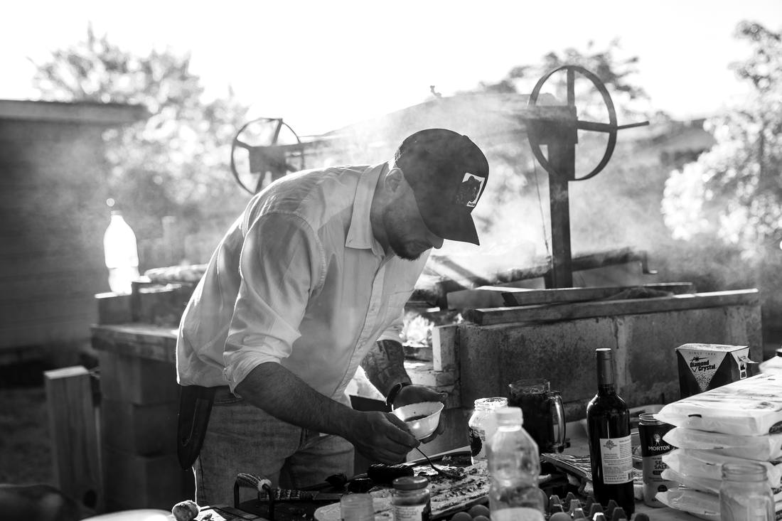 Casa Santise pitmaster working over the fire